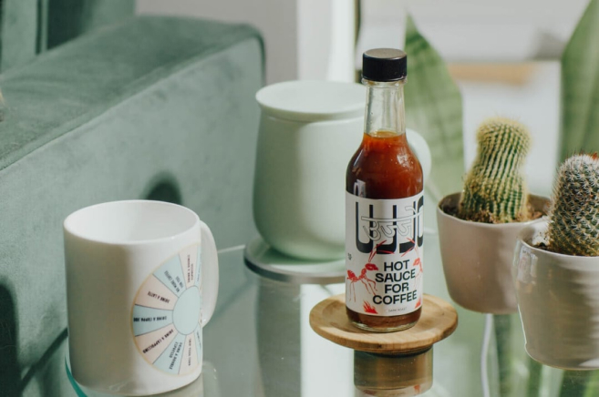 A BOTTLE OF HOT SAUCE UJJO IS ON THE TABLE